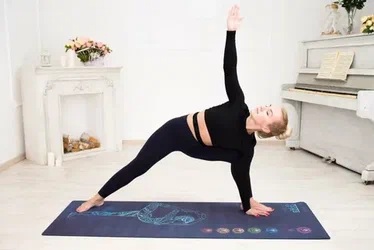 Person performing standing stretches for lower back pain to improve flexibility and relieve back discomfort.