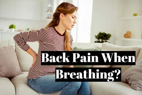 Woman sitting on a couch holding her lower back in pain with text overlay “Back Pain When Breathing?”, illustrating discomfort during deep breathing.