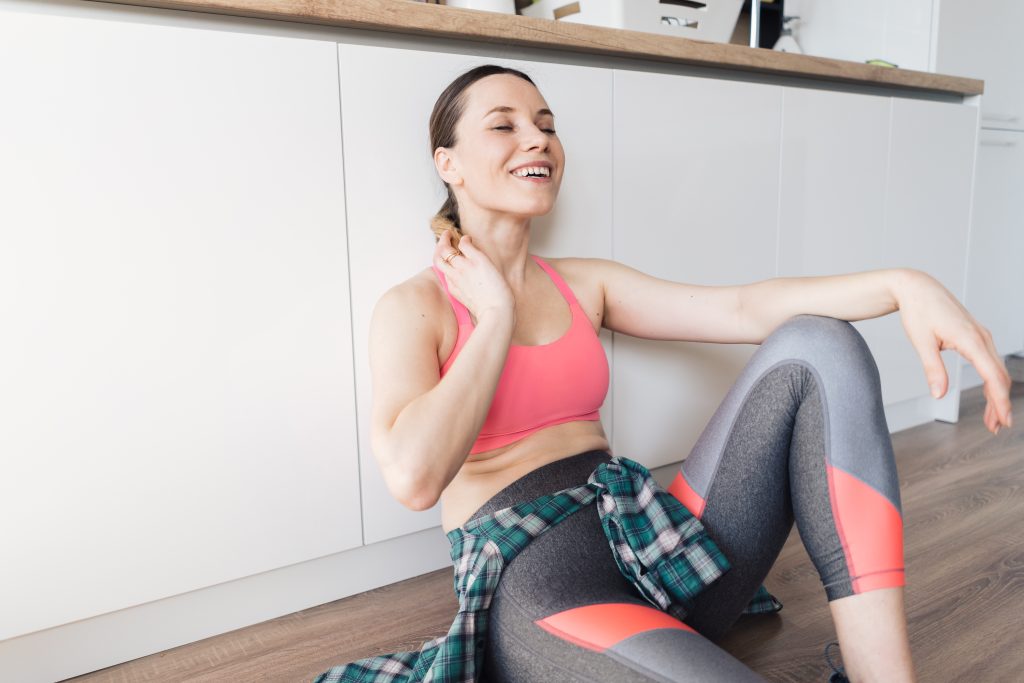 A person performing gentle neck stretching exercises under the guidance of a physical therapist to relieve pain, reduce stiffness, and improve mobility caused by a pinched nerve in the neck.
