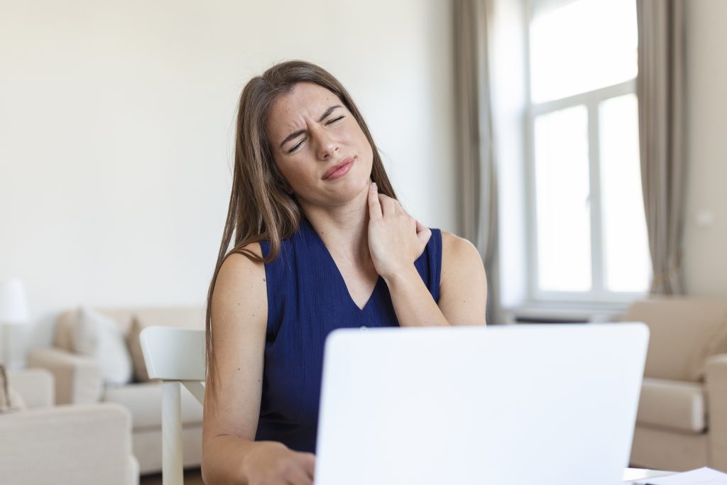 Neck Pain High Blood Pressure Symptoms with person holding neck due to pain and hypertension