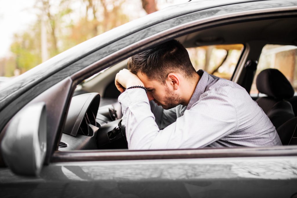 Back Pain While Driving causing lower back discomfort while sitting in a car